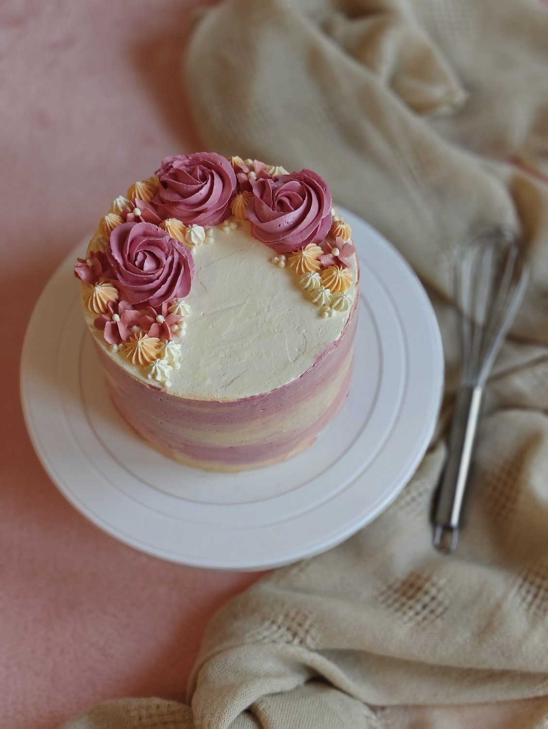 Hand-painted watercolor cake with pink and peach roses